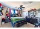 Neutral bedroom features a ceiling fan, guitars, hats, and a full size bed at 7102 W Pueblo Ave, Phoenix, AZ 85043