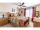 Neutral bedroom features a full size bed, fan, two dressers, and a window at 7102 W Pueblo Ave, Phoenix, AZ 85043