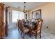 Formal dining room with a large table, elegant chairs, and a modern chandelier at 7102 W Pueblo Ave, Phoenix, AZ 85043