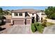 Two-story home with a three-car garage, desert landscaping and well-maintained lawn at 7102 W Pueblo Ave, Phoenix, AZ 85043