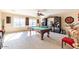 Spacious game room features a pool table, built-in entertainment center, and neutral carpet at 7102 W Pueblo Ave, Phoenix, AZ 85043