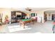 Spacious game room features a pool table, built-in entertainment center, and neutral carpet at 7102 W Pueblo Ave, Phoenix, AZ 85043