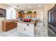 Functional kitchen with an island, tile flooring, and wood cabinets at 7102 W Pueblo Ave, Phoenix, AZ 85043