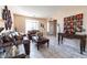 Stylish living room featuring tile flooring, a comfortable leather sofa, and decor at 7102 W Pueblo Ave, Phoenix, AZ 85043