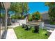 Backyard featuring a modern outdoor kitchen and cozy seating around a linear fireplace at 7710 E Tardes Dr, Scottsdale, AZ 85255