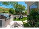 Backyard featuring a modern outdoor kitchen and cozy seating around a linear fireplace at 7710 E Tardes Dr, Scottsdale, AZ 85255
