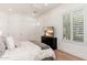 Bedroom with neutral decor, large windows with shutters, and mounted television above the dresser at 7710 E Tardes Dr, Scottsdale, AZ 85255