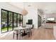 Bright dining area with a large window view, modern light fixture, and hardwood flooring at 7710 E Tardes Dr, Scottsdale, AZ 85255