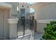 Elegant home featuring a private gated entrance with a turret design and manicured landscaping at 7710 E Tardes Dr, Scottsdale, AZ 85255