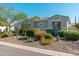 Beautiful desert landscape showcasing a single-story home with low-water plants, cacti, and decorative rocks at 7710 E Tardes Dr, Scottsdale, AZ 85255