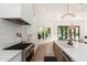 Bright kitchen with island, stainless steel stove, stone countertops, and access to patio at 7710 E Tardes Dr, Scottsdale, AZ 85255