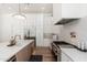 Gourmet kitchen with white cabinets, stainless steel appliances, large island and stone countertops at 7710 E Tardes Dr, Scottsdale, AZ 85255