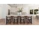 Stylish kitchen with white cabinetry, an expansive island with seating, and contemporary pendant lighting at 7710 E Tardes Dr, Scottsdale, AZ 85255