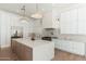 Modern kitchen featuring white cabinets, stainless steel appliances, and a large island at 7710 E Tardes Dr, Scottsdale, AZ 85255