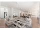 Open-concept living space featuring a large sectional sofa, view into the kitchen, and hardwood flooring at 7710 E Tardes Dr, Scottsdale, AZ 85255