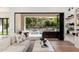 Stylish living room showcasing indoor-outdoor flow with direct access to the backyard pool and patio at 7710 E Tardes Dr, Scottsdale, AZ 85255