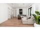 Bright living room with hardwood floors, large sectional sofa, and access to the backyard at 7710 E Tardes Dr, Scottsdale, AZ 85255