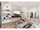Bright living room featuring a modern fireplace, floating shelves, and stylish decor at 7710 E Tardes Dr, Scottsdale, AZ 85255
