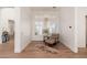 Cozy sitting area with hardwood floors, comfortable chair, and window with bright, filtered light at 7710 E Tardes Dr, Scottsdale, AZ 85255