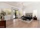 Bright main bedroom featuring tray ceilings, natural light, hardwood floors, and a walk out patio at 7710 E Tardes Dr, Scottsdale, AZ 85255