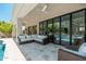 Covered patio with plush seating overlooking a pool and landscaped backyard at 7710 E Tardes Dr, Scottsdale, AZ 85255