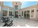 Covered patio featuring travertine tile, chairs, and access to a tower-like structure, great for outdoor relaxation at 7710 E Tardes Dr, Scottsdale, AZ 85255