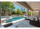 Inviting backyard pool area with comfortable lounge furniture and beautifully landscaped garden at 7710 E Tardes Dr, Scottsdale, AZ 85255
