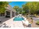 Beautiful backyard with a sparkling pool, inviting lounge areas, and desert landscaping under a bright sky at 7710 E Tardes Dr, Scottsdale, AZ 85255