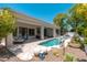 Lush backyard with a pool, covered patios, lounge seating, and beautiful desert landscaping at 7710 E Tardes Dr, Scottsdale, AZ 85255