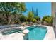 Inviting backyard pool and spa with well-manicured landscaping and lush greenery at 7710 E Tardes Dr, Scottsdale, AZ 85255