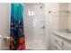 Bathroom featuring stand up shower with colorful sea life curtain, white walls and storage at 7807 E Main St # E2, Mesa, AZ 85207