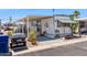 Charming mobile home featuring covered patio and unique outdoor decor at 7807 E Main St # E2, Mesa, AZ 85207