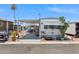 Charming manufactured home with mature desert landscaping and a covered carport at 7807 E Main St # E2, Mesa, AZ 85207