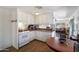 Open kitchen layout with white cabinets and view into the living room at 7807 E Main St # E2, Mesa, AZ 85207