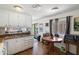 Functional kitchen with wooden flooring, white cabinets, and eating area at 7807 E Main St # E2, Mesa, AZ 85207