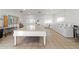 Well-lit community laundry room with multiple washers and folding table at 7807 E Main St # E2, Mesa, AZ 85207