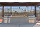 Outdoor grilling area featuring stainless steel grills and convenient counter space under a shaded pergola at 7807 E Main St # E2, Mesa, AZ 85207