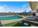 Backyard oasis with a swimming pool, waterfall feature, and lounge chairs at 818 N Terrace St, Mesa, AZ 85203