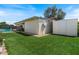 Expansive backyard featuring lush artificial grass, a covered patio and convenient storage shed at 818 N Terrace St, Mesa, AZ 85203