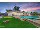 Backyard oasis showcasing a pool, hot tub, putting green, and ample seating areas at 818 N Terrace St, Mesa, AZ 85203