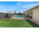 Relaxing backyard featuring string lights, stylish patio furniture, and a sparkling pool with deck at 818 N Terrace St, Mesa, AZ 85203