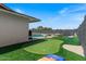 Lush backyard featuring a putting green, sandy area, and a pool beyond at 818 N Terrace St, Mesa, AZ 85203
