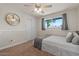 Cozy bedroom featuring a window, ceiling fan, and closet space at 818 N Terrace St, Mesa, AZ 85203