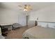 Inviting bedroom with desk, comfortable chair, a ceiling fan, and carpeted floors at 818 N Terrace St, Mesa, AZ 85203