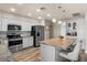 Charming kitchen with stainless steel appliances, granite counters and convenient island seating at 818 N Terrace St, Mesa, AZ 85203