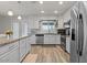 Well-lit kitchen with white cabinets, stainless steel appliances, and a functional layout at 818 N Terrace St, Mesa, AZ 85203