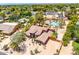 Beautiful aerial view of custom home featuring a lush backyard with a pool, mature trees and tennis court at 8606 S Dorsey Ln, Tempe, AZ 85284