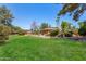 Backyard with green grass, mature trees, and a gazebo at 8606 S Dorsey Ln, Tempe, AZ 85284