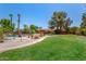 Expansive backyard features a pool, spa, gazebo, mature trees, and lush green grass, perfect for outdoor living at 8606 S Dorsey Ln, Tempe, AZ 85284