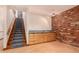 The basement area includes carpeted stairs, a small wet bar, and brick accent wall at 8606 S Dorsey Ln, Tempe, AZ 85284